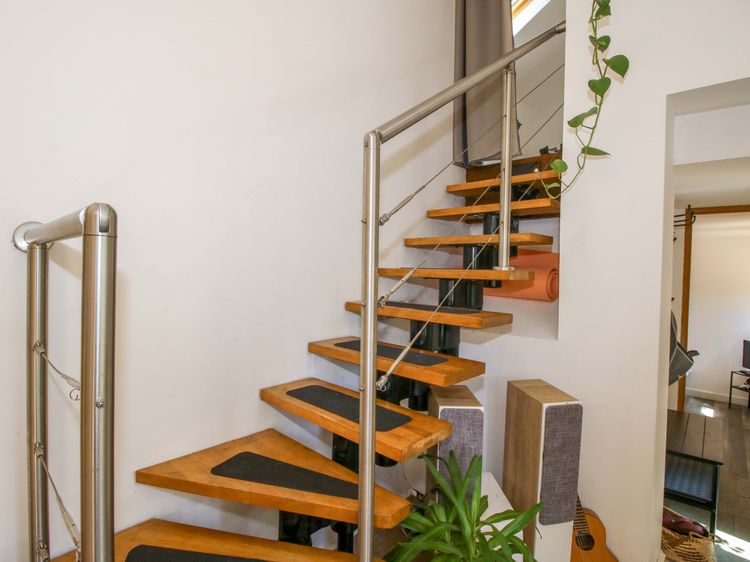 Painted stairwell beside timber stairs