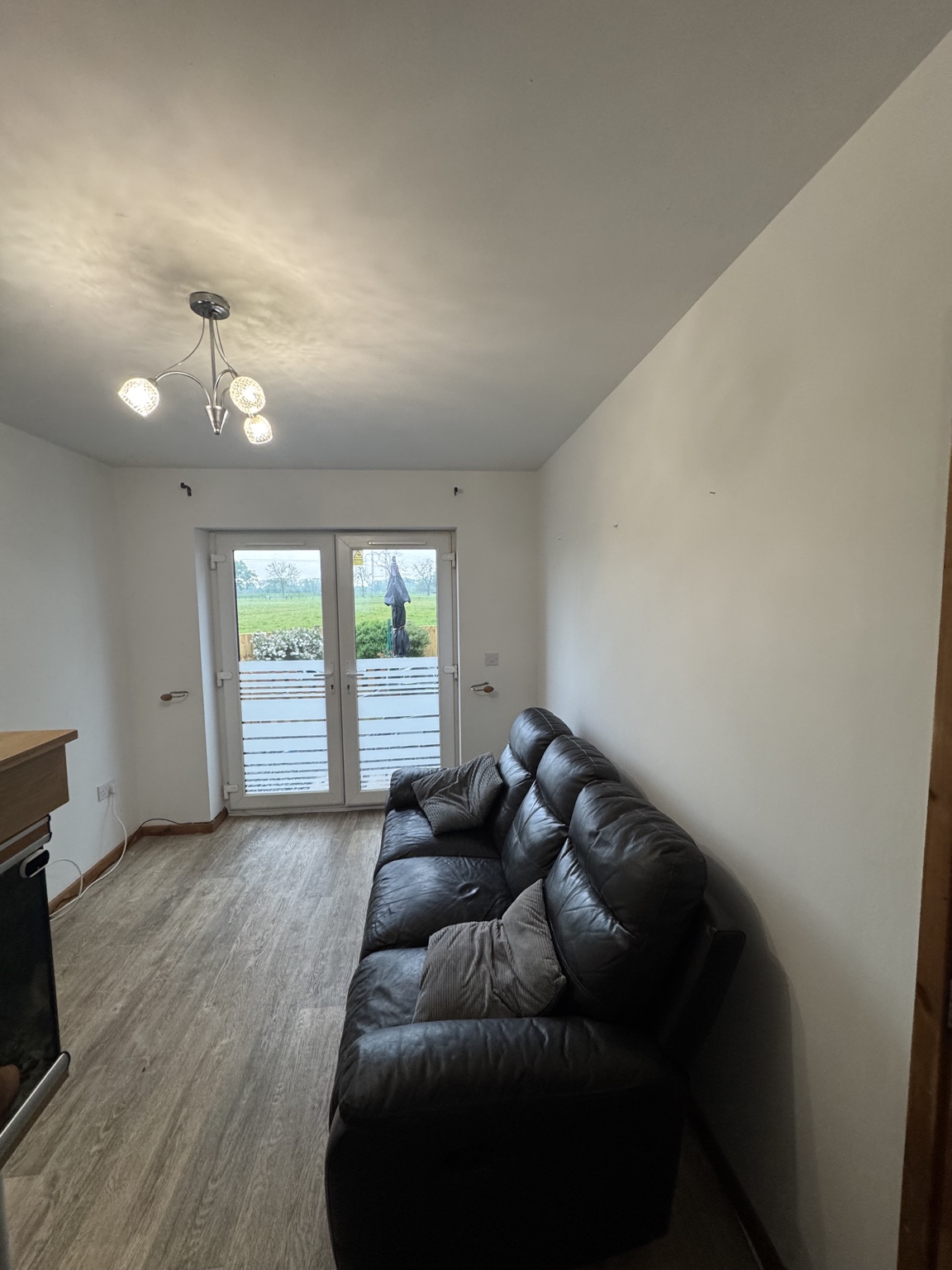 Living area after refresh with light walls and new flooring